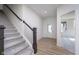 Welcoming entry foyer with staircase, decorative front door, and wood flooring at 18944 Seaforth Way, Westfield, IN 46074