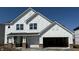 New construction featuring a white exterior, brick accents, an attached two-car garage and a covered porch entry at 18944 Seaforth Way, Westfield, IN 46074