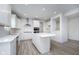 Modern kitchen showcasing a center island, white cabinets, and stainless steel appliances at 18944 Seaforth Way, Westfield, IN 46074