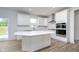 Bright kitchen featuring a center island, white cabinets, and modern appliances at 18944 Seaforth Way, Westfield, IN 46074