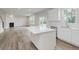 Open concept kitchen featuring a kitchen island, stainless steel appliances, and wood flooring at 18944 Seaforth Way, Westfield, IN 46074
