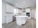 Bright kitchen featuring white cabinets, stainless steel appliances, and a large island at 18944 Seaforth Way, Westfield, IN 46074
