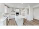 Bright kitchen featuring white cabinets, stainless steel appliances, island and wood flooring at 18944 Seaforth Way, Westfield, IN 46074