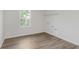 Well lit laundry room with wood-look flooring and window at 18944 Seaforth Way, Westfield, IN 46074