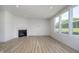 Bright living room with a fireplace and large windows overlooking the backyard at 18944 Seaforth Way, Westfield, IN 46074