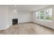 Sun-filled living room with a modern fireplace and wood flooring at 18944 Seaforth Way, Westfield, IN 46074