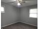 Bedroom with two windows offering natural light, ceiling fan, and hardwood flooring at 1931 Brentwood Dr, Anderson, IN 46011