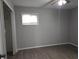 Bedroom with natural light from the window, hardwood flooring, and closet space at 1931 Brentwood Dr, Anderson, IN 46011