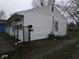 The house has a side door, air conditioning unit, and a chain link fence at 1931 Brentwood Dr, Anderson, IN 46011
