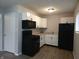 Well lit kitchen featuring white cabinets, black appliances, and sleek countertops at 1931 Brentwood Dr, Anderson, IN 46011