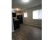 Open kitchenette area with ample lighting, vinyl flooring, and modern black appliances at 1931 Brentwood Dr, Anderson, IN 46011
