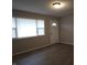 View of front door and window featuring wood-look flooring and new paint at 1931 Brentwood Dr, Anderson, IN 46011