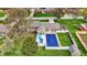 Aerial view of a home with a pool, a patio area with seating, and a large grassy yard at 2001 Winchester Dr, Indianapolis, IN 46227