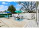 Charming backyard deck with outdoor seating, surrounded by a white fence and colorful umbrellas at 2001 Winchester Dr, Indianapolis, IN 46227