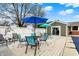 Backyard deck featuring a dining area with blue and teal umbrellas and a view of the home at 2001 Winchester Dr, Indianapolis, IN 46227