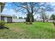 Expansive backyard with lush green grass, mature trees, and a charming fence, perfect for outdoor activities at 2001 Winchester Dr, Indianapolis, IN 46227