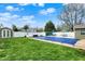 Spacious backyard featuring a fenced pool, a shed, and ample green space, perfect for outdoor enjoyment at 2001 Winchester Dr, Indianapolis, IN 46227