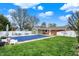 Expansive backyard featuring a large covered pool with blue umbrellas and outdoor seating at 2001 Winchester Dr, Indianapolis, IN 46227