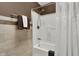 Bathroom featuring tiled walls, modern fixtures, and shower and tub combination at 2001 Winchester Dr, Indianapolis, IN 46227