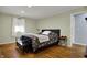 Serene bedroom with hardwood floors, neutral wall color, and natural light, creating a calm and inviting space at 2001 Winchester Dr, Indianapolis, IN 46227