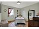 Light-filled bedroom with hardwood floors, decorative window treatment and comfortable decor at 2001 Winchester Dr, Indianapolis, IN 46227