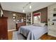 Comfortable bedroom featuring hardwood floors, vintage dresser, and built-in bookshelves at 2001 Winchester Dr, Indianapolis, IN 46227