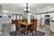 Open concept dining area featuring a chandelier, tile floors, and stainless steel appliances at 2001 Winchester Dr, Indianapolis, IN 46227