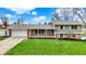 Charming home with an attached garage, green lawn, brick facade, and a welcoming front porch at 2001 Winchester Dr, Indianapolis, IN 46227