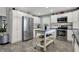 Modern kitchen featuring white cabinetry, stainless steel appliances, and a center island at 2001 Winchester Dr, Indianapolis, IN 46227