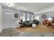 Bright living room featuring neutral decor, large windows, and a comfortable seating area at 2001 Winchester Dr, Indianapolis, IN 46227