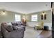 Cozy living room featuring a large couch, hardwood floors, chair, and comfortable decor at 2001 Winchester Dr, Indianapolis, IN 46227