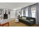 Cozy living room with a sofa, stairs to the upper level, and large windows with natural light at 2001 Winchester Dr, Indianapolis, IN 46227