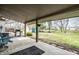 Covered patio overlooking the backyard, with a grill, seating and space for relaxing at 2034 Milburn Dr, Brownsburg, IN 46112