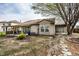 Backyard featuring a stone path, mature tree, covered patio with porch swing, and small garden bed at 2034 Milburn Dr, Brownsburg, IN 46112
