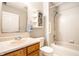 Full bathroom with tiled tub, a mirrored vanity, and ample lighting for daily comfort at 2034 Milburn Dr, Brownsburg, IN 46112