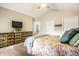 Primary bedroom with vaulted ceiling, ceiling fan, warm tones, carpeted floors and decorative trunk at 2034 Milburn Dr, Brownsburg, IN 46112
