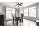 Dining area with a glass top table, wood floors, and a sliding glass door to the backyard at 2034 Milburn Dr, Brownsburg, IN 46112