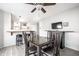 Dining area with a glass top table, bar seating, and a view into the living room at 2034 Milburn Dr, Brownsburg, IN 46112