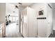 Hallway with light gray plank flooring leading into a living space and a kitchen with a white refrigerator at 2034 Milburn Dr, Brownsburg, IN 46112