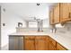 Bright kitchen featuring wood cabinets, white countertop and stainless steel dishwasher at 2034 Milburn Dr, Brownsburg, IN 46112