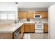 Traditional kitchen with wood cabinets, white countertops, and white appliances at 2034 Milburn Dr, Brownsburg, IN 46112
