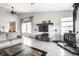 Bright living room featuring hardwood floors, wood-burning stove, and access to the kitchen at 2034 Milburn Dr, Brownsburg, IN 46112