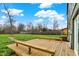 Wide backyard showing a wooden deck surrounded by greenery, perfect for relaxation and entertainment at 2103 Postmaster Ln, Greenfield, IN 46140