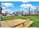 Expansive backyard with a wooden deck, shed, and open green space for outdoor activities at 2103 Postmaster Ln, Greenfield, IN 46140