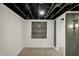 Finished basement boasting a painted open ceiling, industrial style lighting, and a decorative dart board at 2103 Postmaster Ln, Greenfield, IN 46140