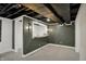 Finished basement with a serving area, trendy lighting, and an open ceiling design for modern appeal at 2103 Postmaster Ln, Greenfield, IN 46140