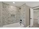 Bathroom features a white tiled tub, a leaf-patterned wall, and sleek black fixtures at 2103 Postmaster Ln, Greenfield, IN 46140