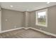 Comfortable bedroom with neutral paint, plush carpet, and a bright window overlooking the outdoors at 2103 Postmaster Ln, Greenfield, IN 46140