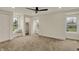 Light-filled bedroom with plush carpet, multiple windows, and a cozy window seat at 2103 Postmaster Ln, Greenfield, IN 46140