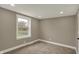 Bright bedroom with neutral walls, soft carpeting, and natural light from the large window at 2103 Postmaster Ln, Greenfield, IN 46140